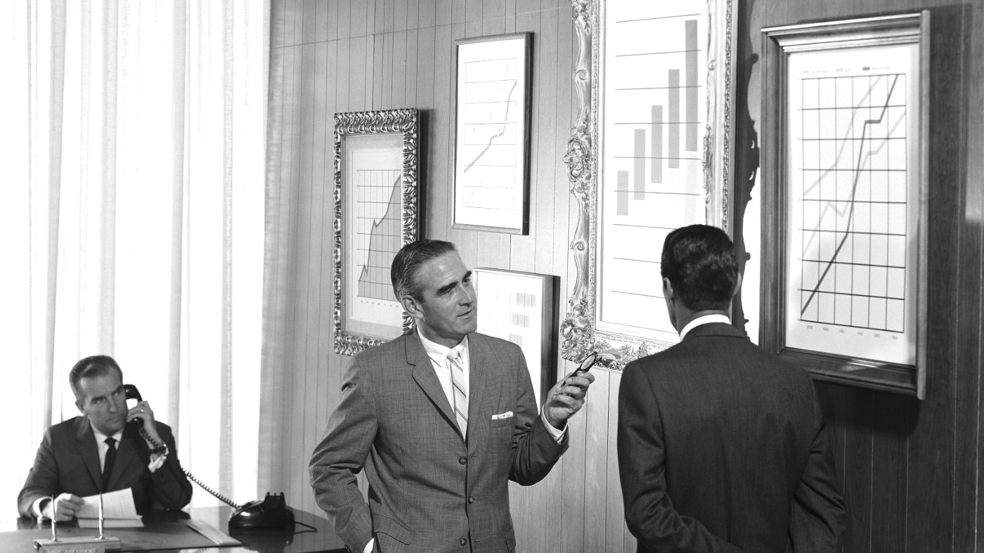 Businessmen discussing graphs of business results